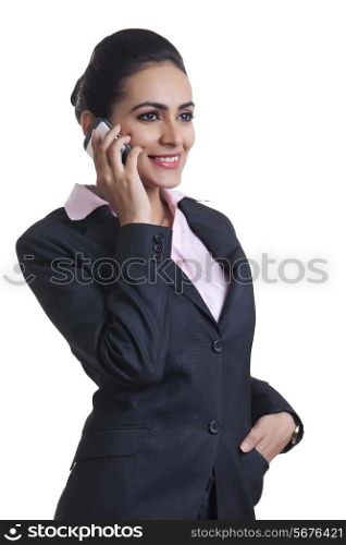 Happy young Indian businesswoman using cell phone over white background