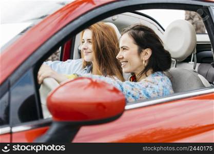 happy young ladies sitting car