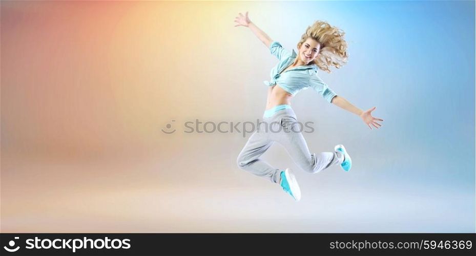 Happy young lady exercising and dancing