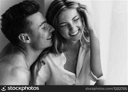 happy young loving couple smiling. Young couple in love have fun i on new years eve or st valentines day. black and white photo of young couple.. happy young loving couple smiling. Young couple in love have fun i on new years eve or st valentines day. black and white photo of young couple