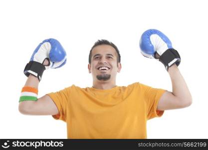 Happy young male boxer looking up over white background