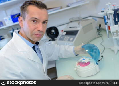 happy young male researcher working in his lab