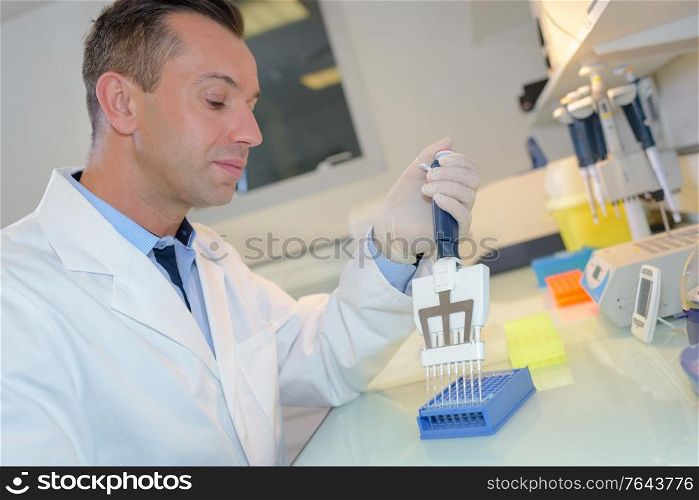 happy young male researcher working in his lab