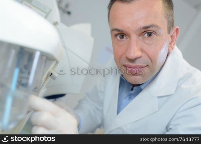 happy young male researcher working in his lab