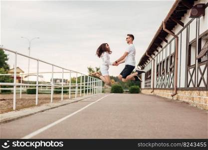 happy young man and woman jumping and having fun outdoors on a warm summer day. horse rancho.. happy young man and woman jumping and having fun outdoors on a warm summer day. horse rancho