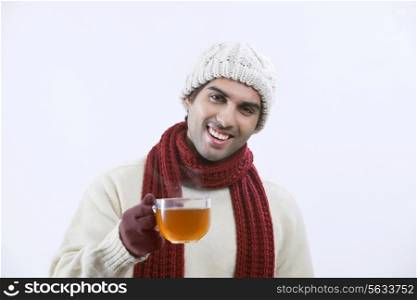 Happy young man drinking black tea over white background