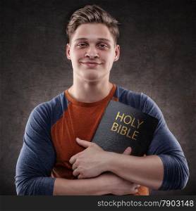 Happy young man embrace his Holy Bible