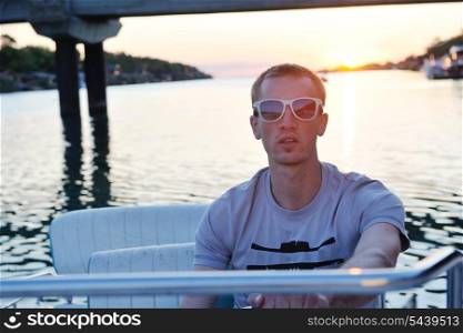 happy young man have fun at boat at sunset on summer season