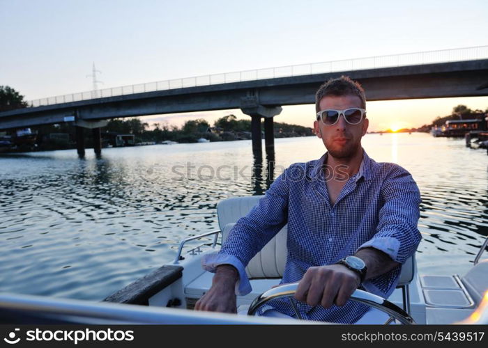 happy young man have fun at boat at sunset on summer season