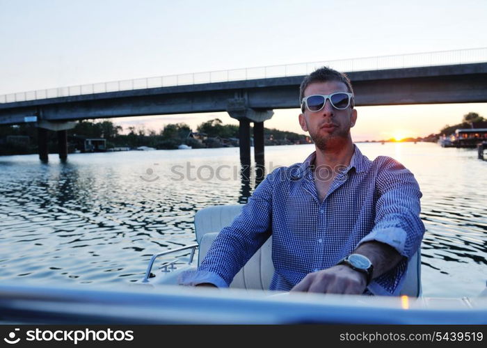 happy young man have fun at boat at sunset on summer season