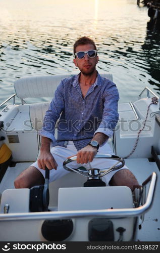 happy young man have fun at boat at sunset on summer season