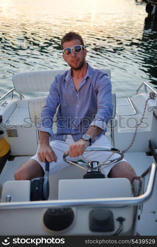 happy young man have fun at boat at sunset on summer season