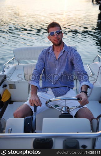 happy young man have fun at boat at sunset on summer season