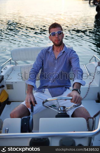 happy young man have fun at boat at sunset on summer season