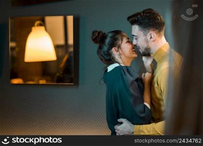happy young man hugging cheerful woman room