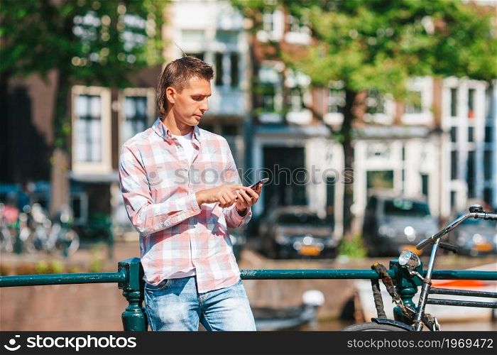 Happy young man in Amsterdam. Happy young man with a city map in european city