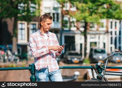 Happy young man in Amsterdam. Happy young man with a city map in european city