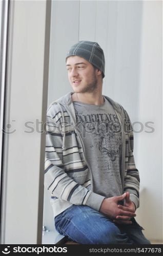 happy young man in fashion clothing posing