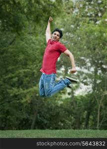 Happy young man jumping in park