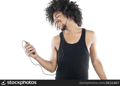 Happy young man listening to mp3 player over white background