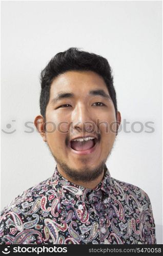 Happy young man looking away against white background