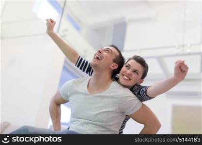 happy young man piggybacking his girlfriend at home