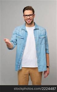 Happy Young Man Presenting standing grey White Background.. Happy Young Man Presenting standing grey White Background