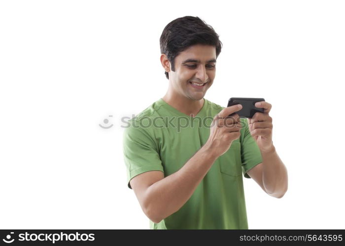 Happy young man reading text message over white background