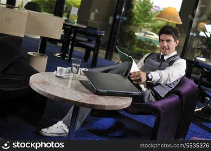 Happy young man sitting relaxed working on computer
