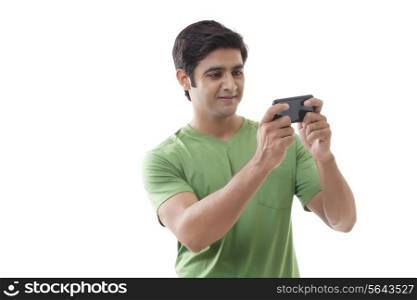 Happy young man texting message over white background