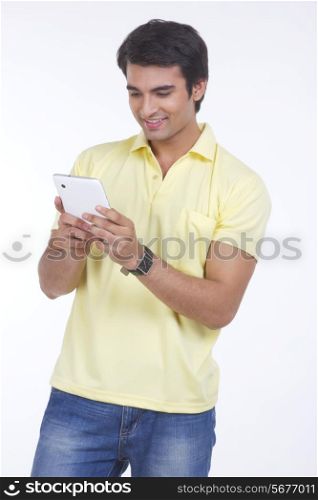 Happy young man using digital tablet over white background