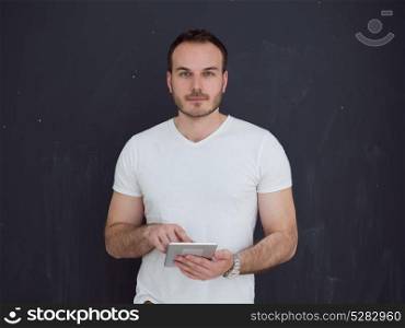 Happy young man using tablet computer isolated over gray background