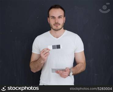 Happy young man using tablet computer isolated over gray background