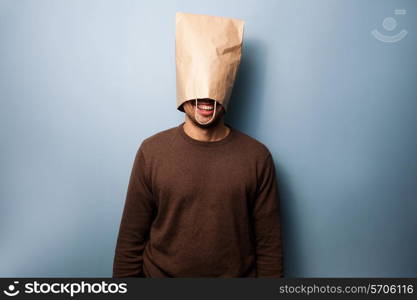 happy young man with a paper bag on his head