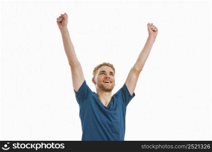 Happy young man with both arms up, isolated on white background