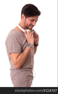 Happy young man with headphones on and listening to music