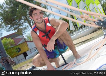 happy young man with security vest about to sail