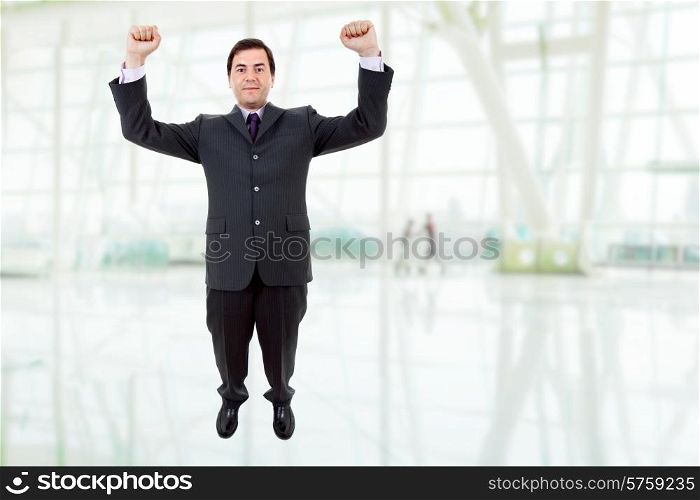 happy young man with wide open arms at the office