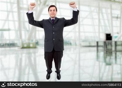 happy young man with wide open arms at the office