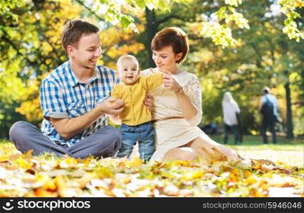 Happy young parents with cute baby