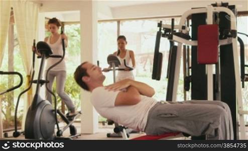Happy young people, fun, leisure, lifestyle, fitness, sport and exercising, man and women working out in gym. 13of27