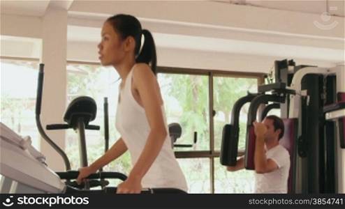 Happy young people, fun, leisure, lifestyle, fitness, sport and workout, man and woman training in gym. Portrait of asian girl looking at camera when jogging on treadmill, 16of27