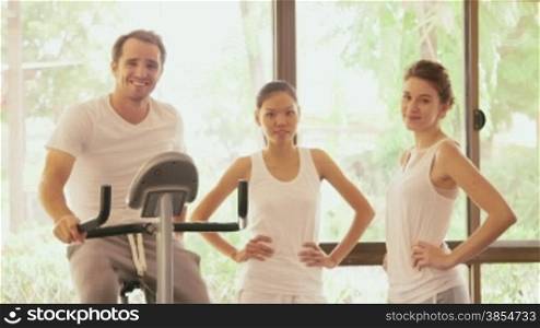 Happy young people, fun, leisure, lifestyle, gym, sports and training. Group of happy friends, man and girls talking, laughing and having fun in fitness club. Portrait smiling at camera, 18of27