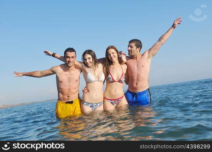 happy young people group have fun run and jump on beach beautiful sand beach