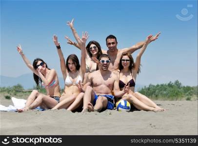 happy young people group have fun run and jump on beach beautiful sand beach