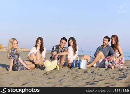 happy young people group have fun run and jump on beach beautiful sand beach