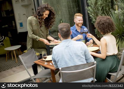 Happy young people have lunch in the courtyard and have a fun