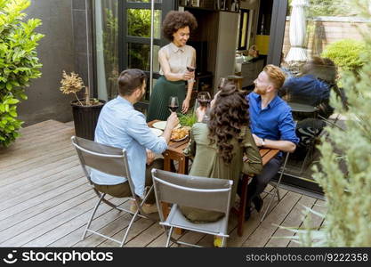 Happy young people have lunch in the courtyard and have a fun