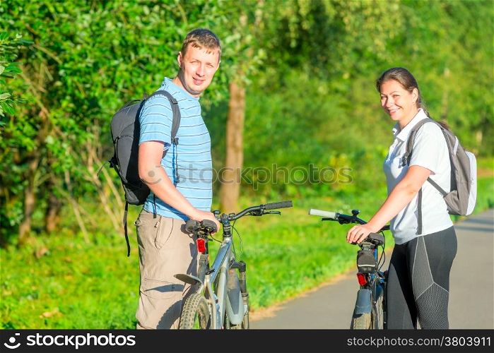 happy young people riding bikes