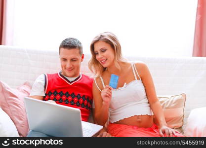 Happy young pregnant woman with husband making on-line purchases&#xA;